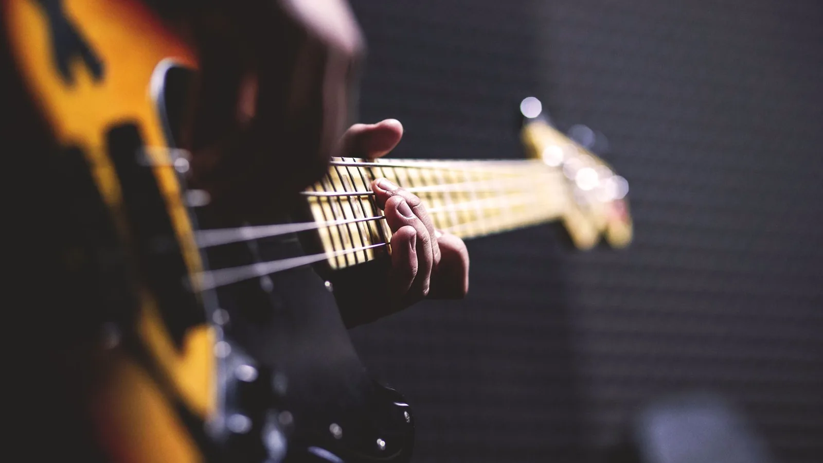 Someone playing an electric bass