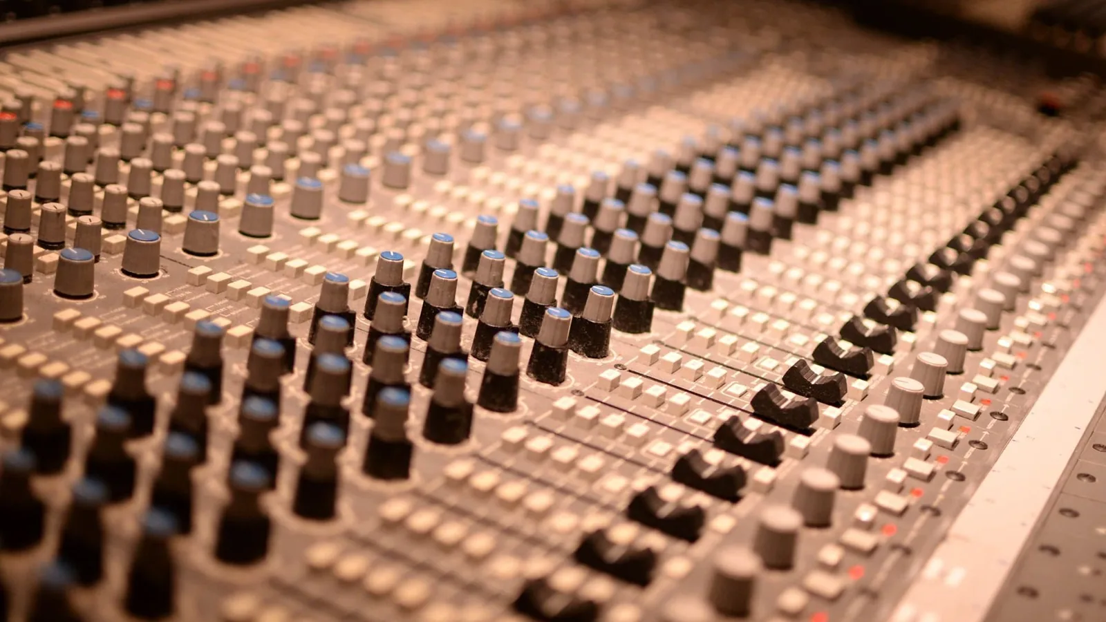 Faders on a large mixing console