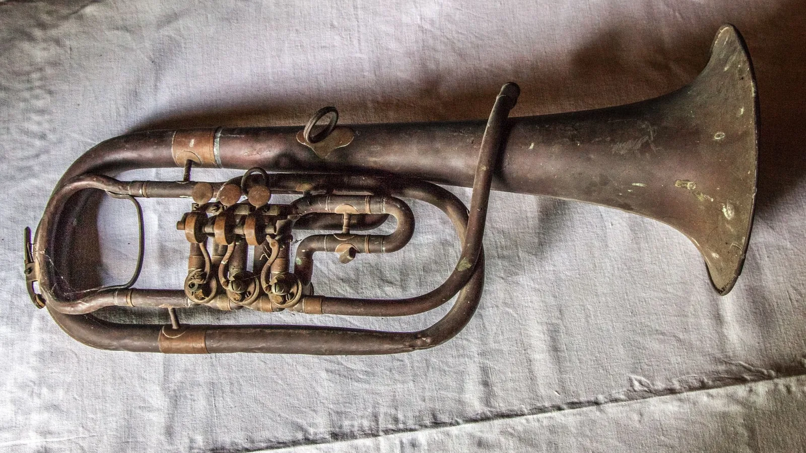 A trumpet resting on fabric