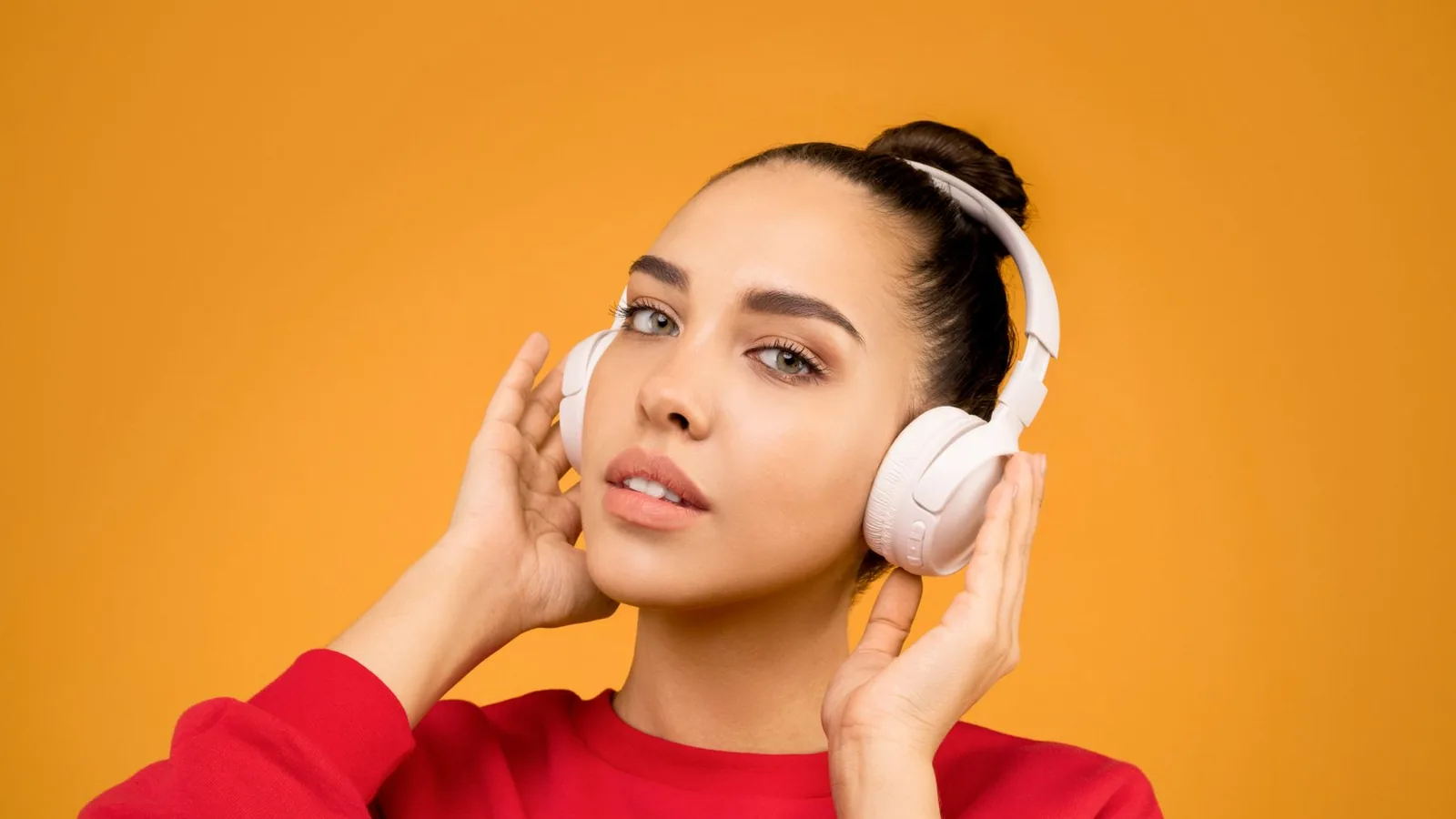 A woman listening with headphones