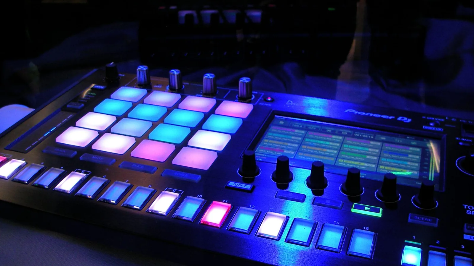 A music controller lit in blue and purple