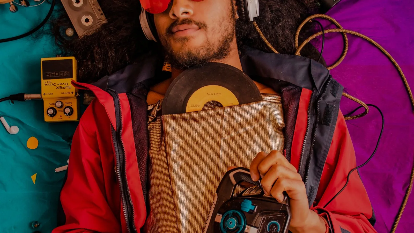 Musical gear arranged on a colorful background
