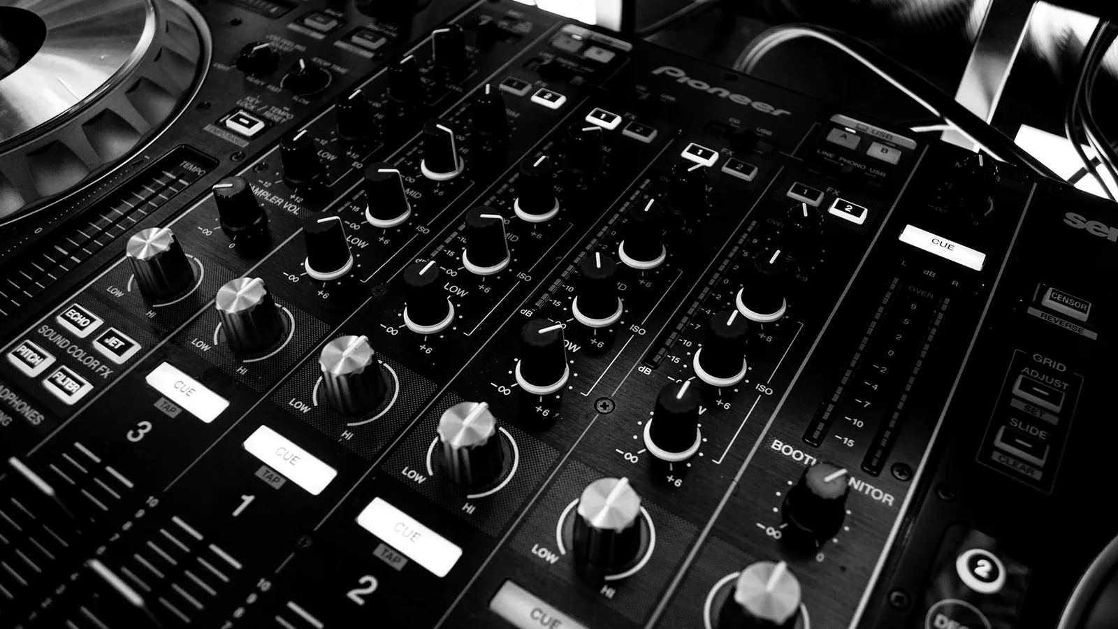 A close-up of a DJ mixer
